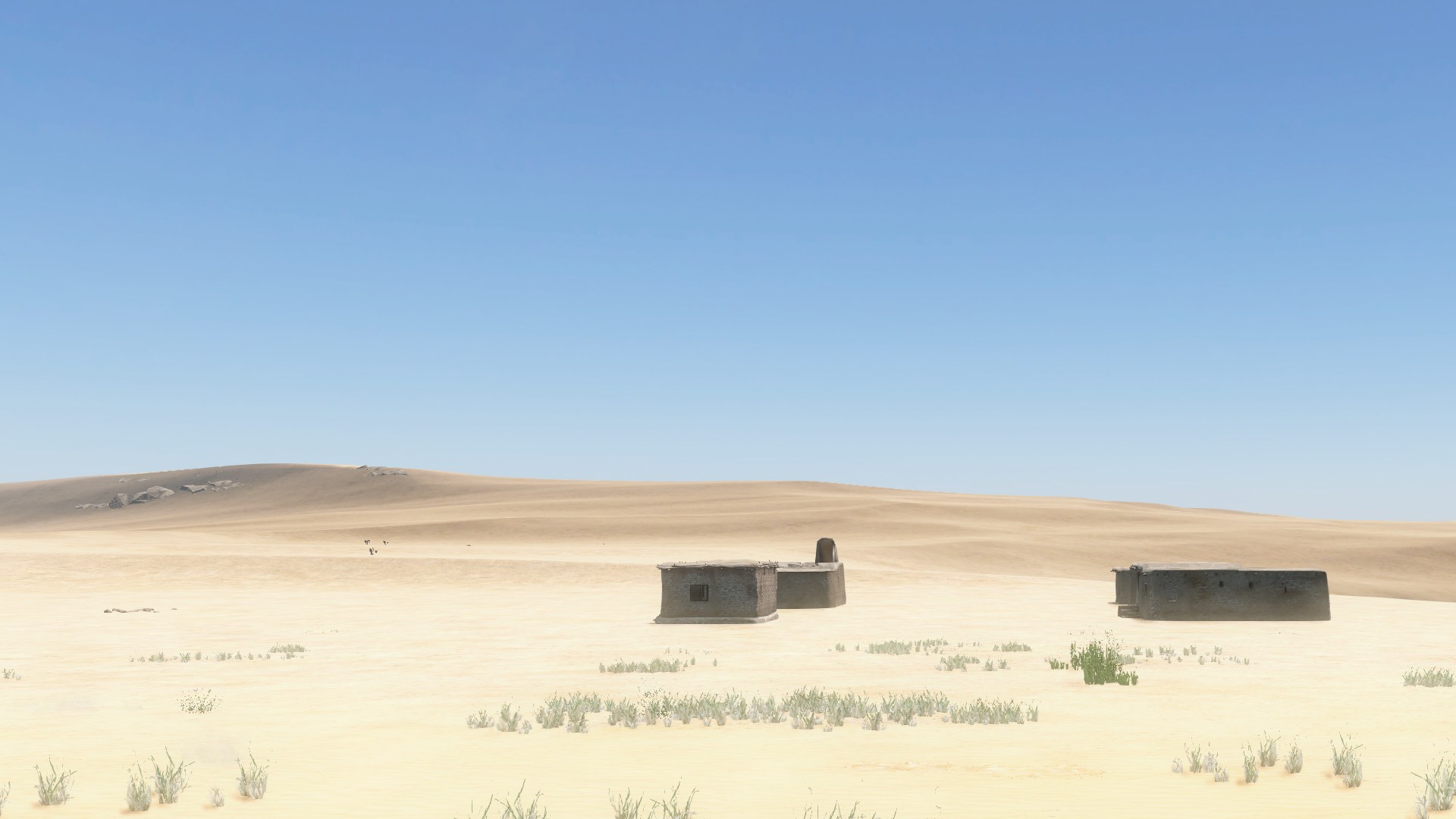 Two mud-brick houses alone in an empty sandy desert